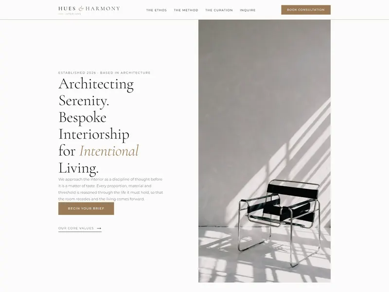 The Hues and Harmony Interiors homepage, a serif headline beside a chair in window light